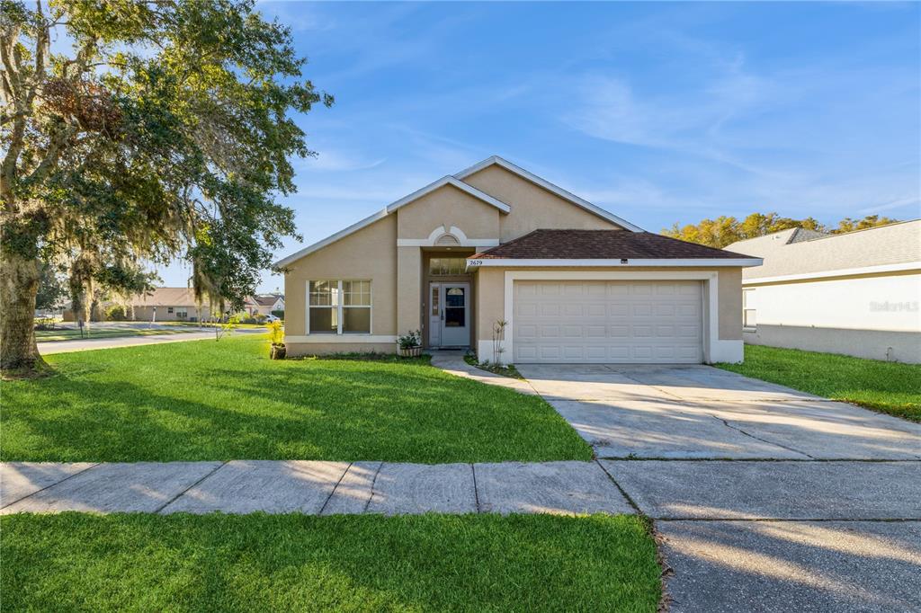 a front view of a house with a yard and garage