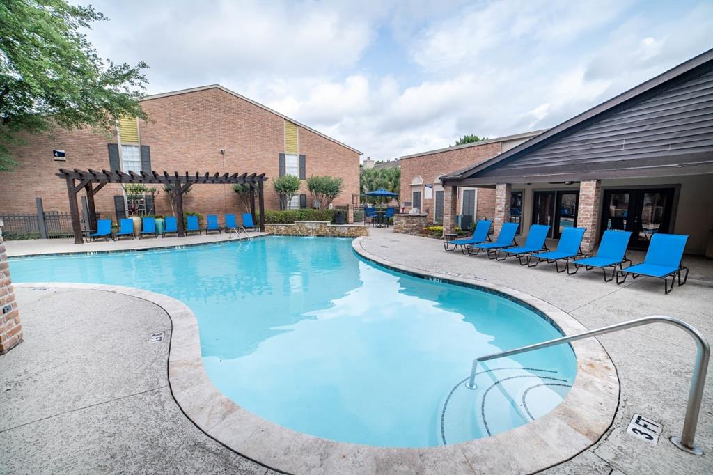 a view of a swimming pool with a lounge chairs