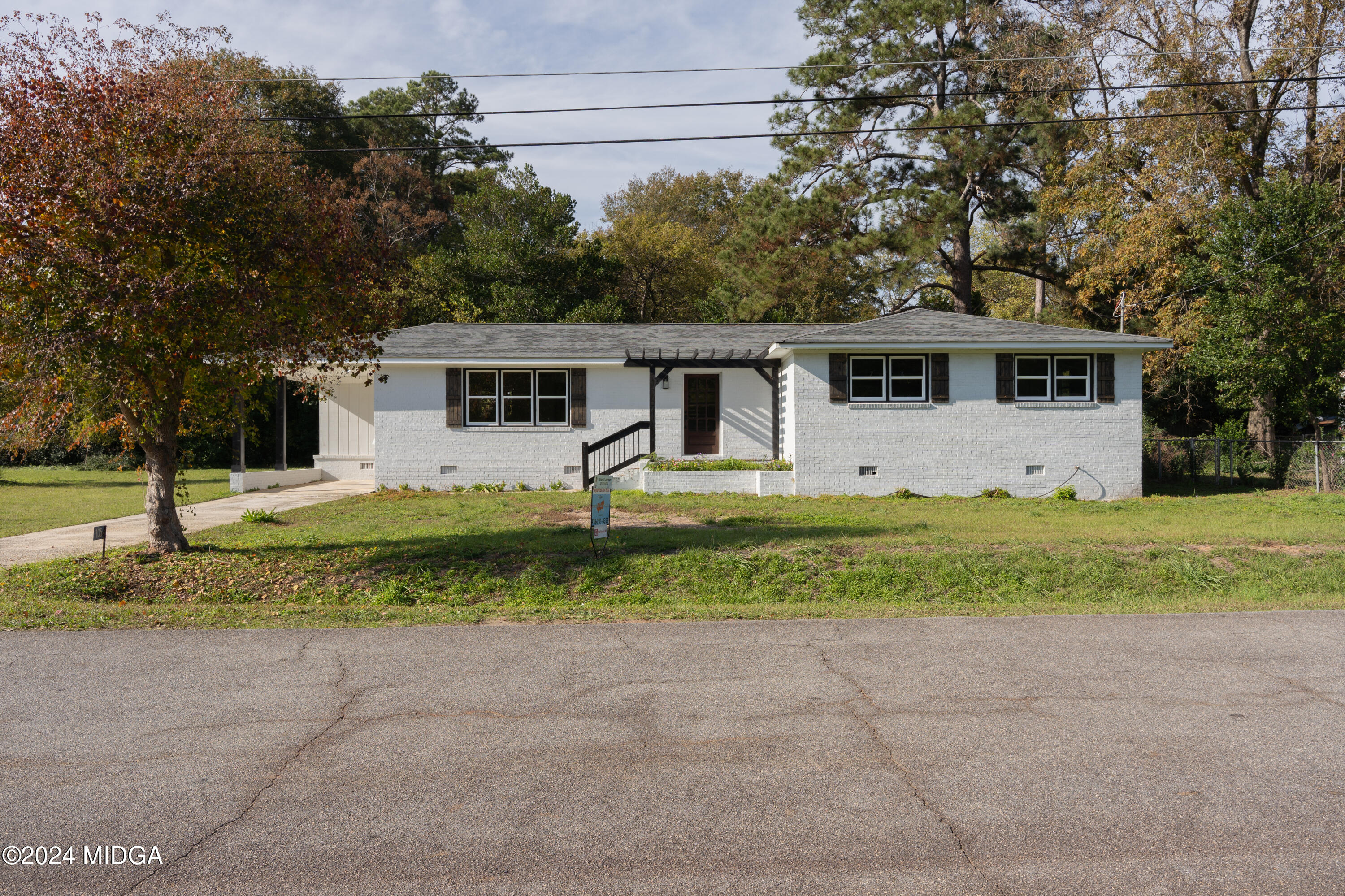 a front view of house with yard and green space