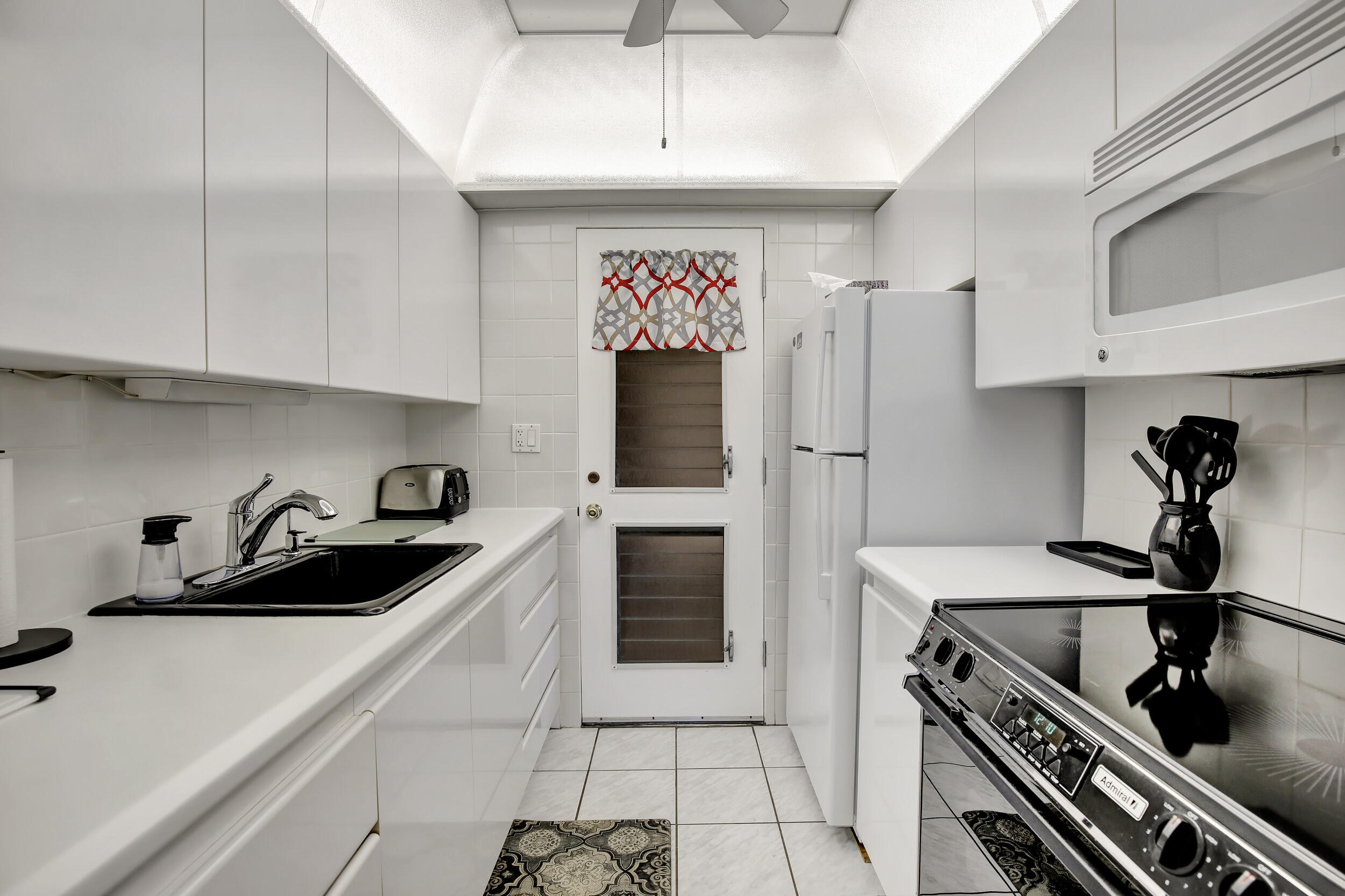 a kitchen with a sink stainless steel appliances and cabinets