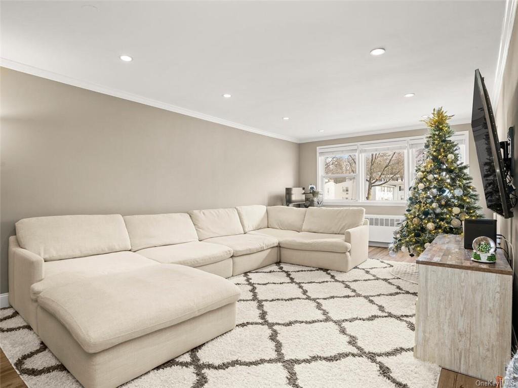 a living room with furniture and a christmas tree