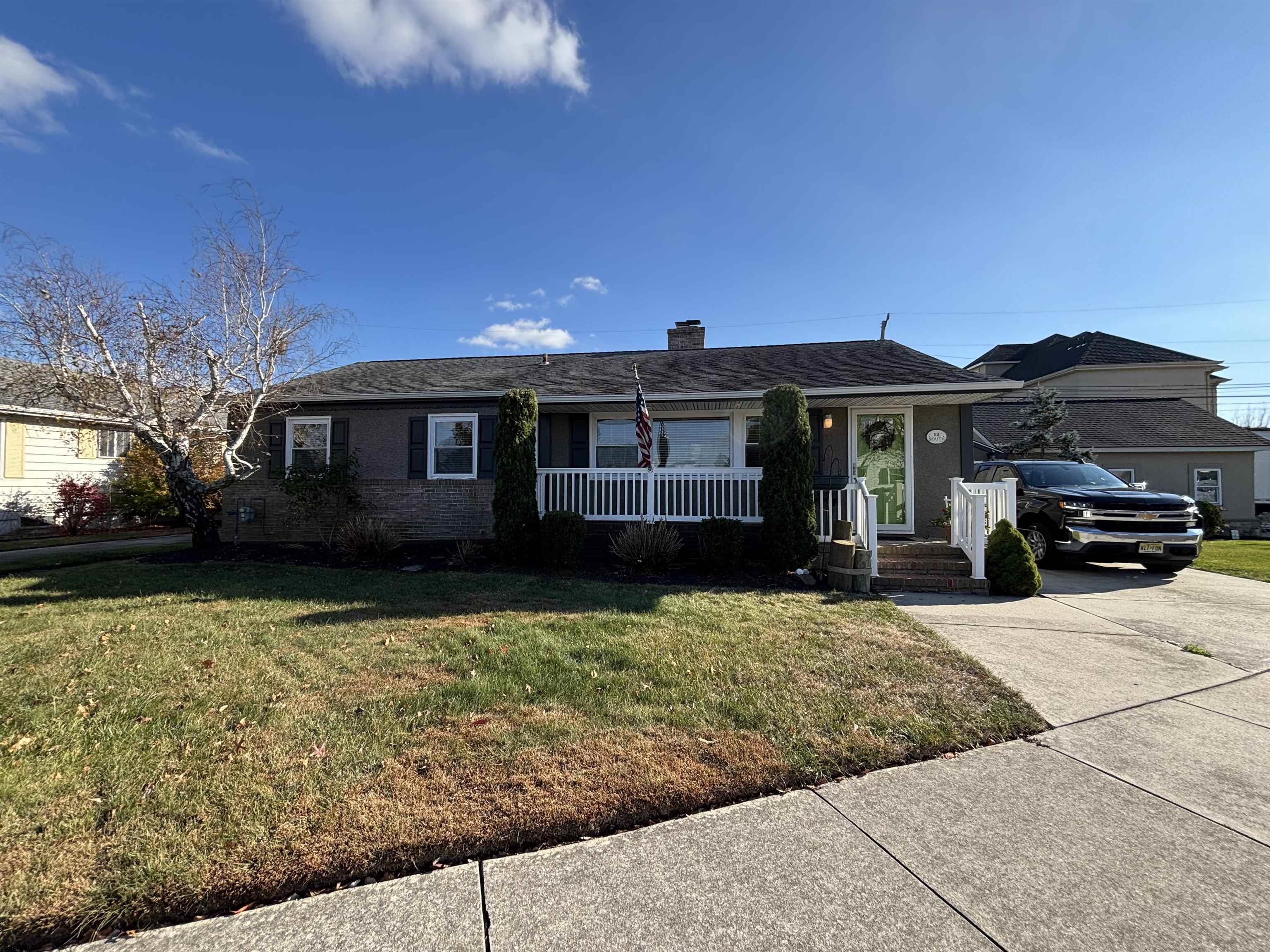 a front view of a house with a garden