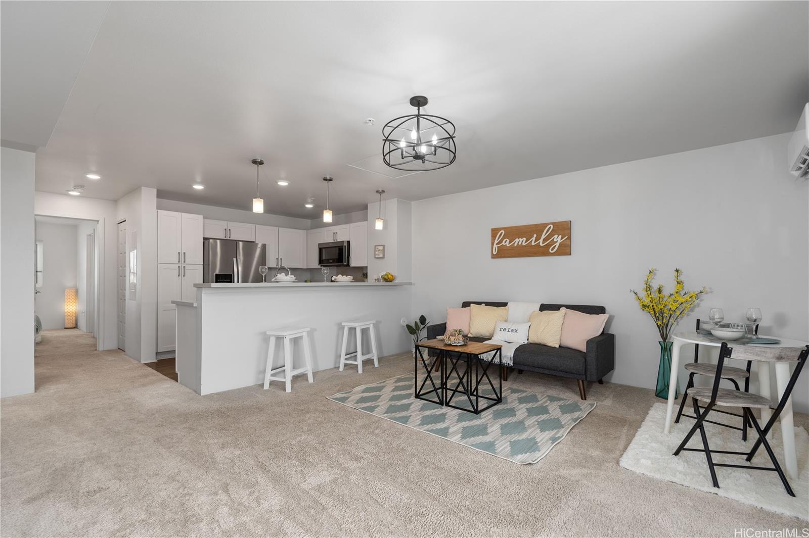 Living area with kitchen and primary bedroom