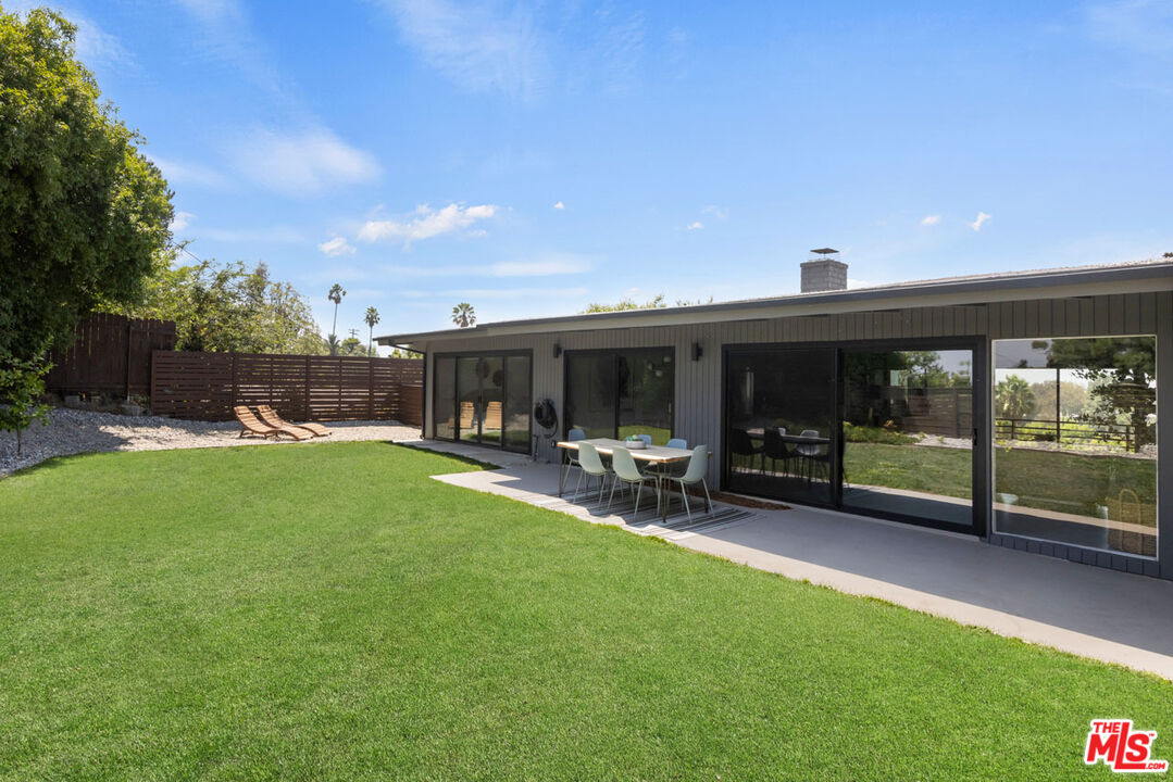 a view of a house with backyard porch and sitting area