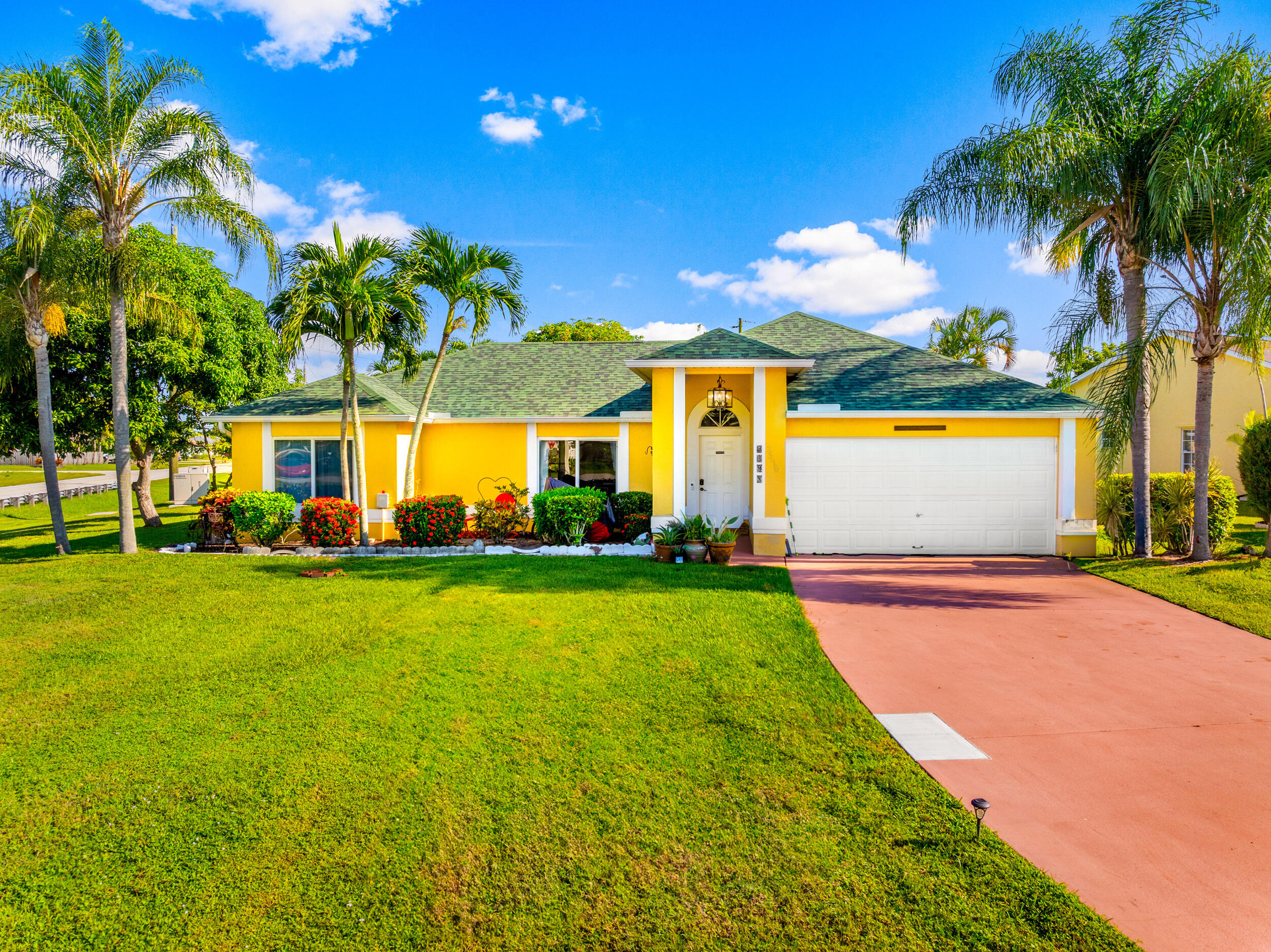 a view of a house with a backyard and a patio