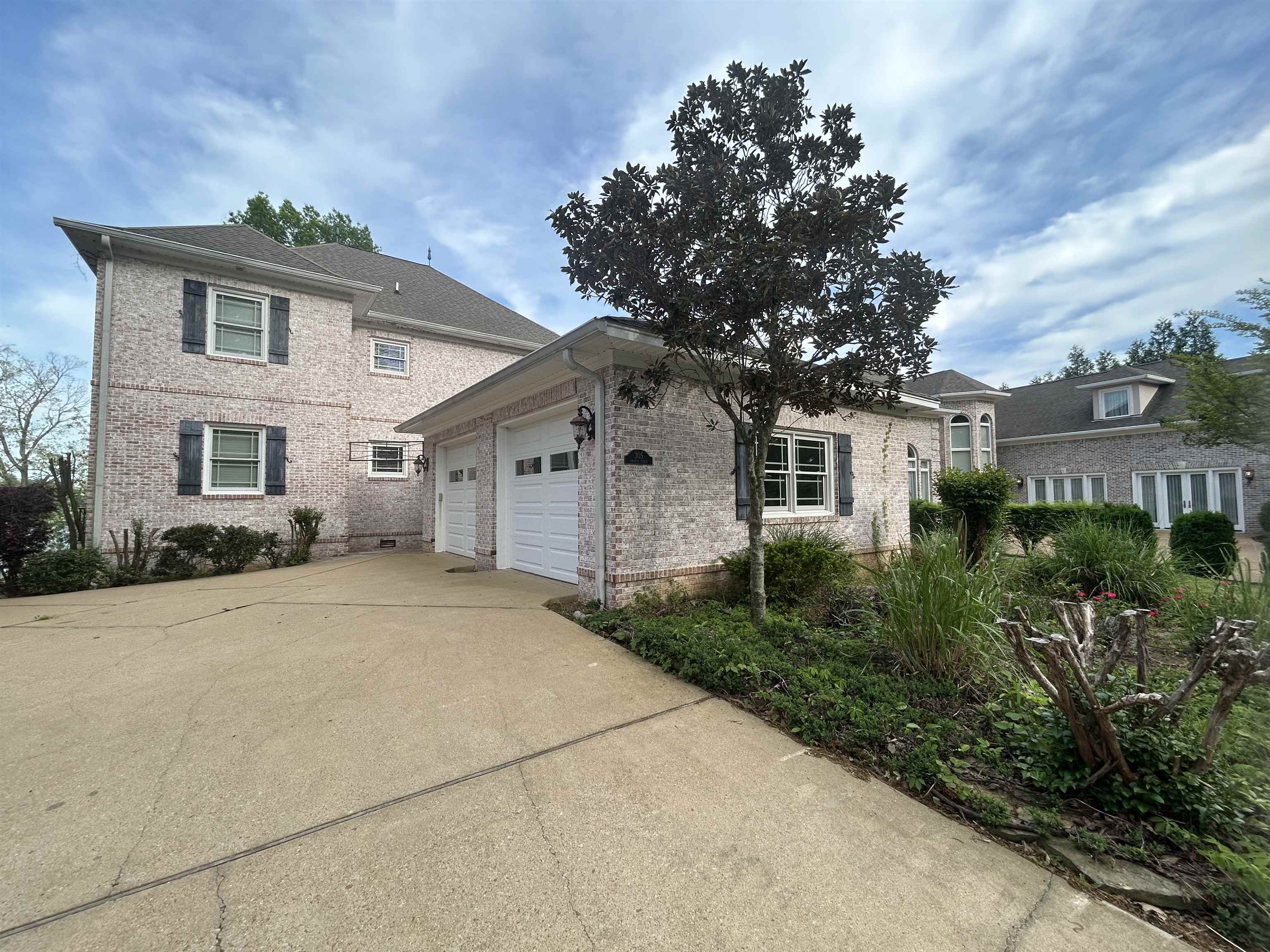 a front view of a house with a garden