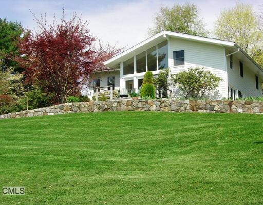 a front view of house with yard and green space