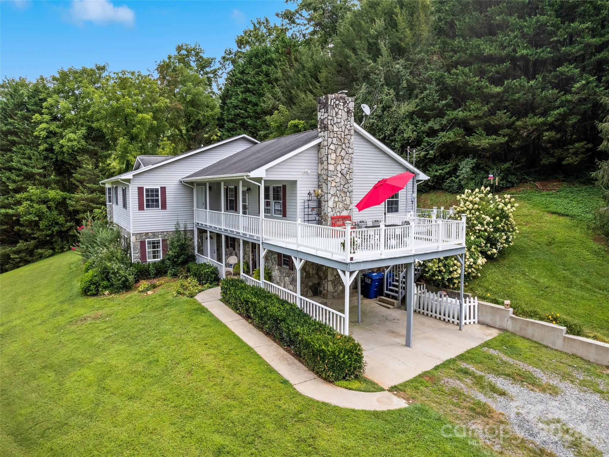 a view of house with swimming pool and outdoor seating