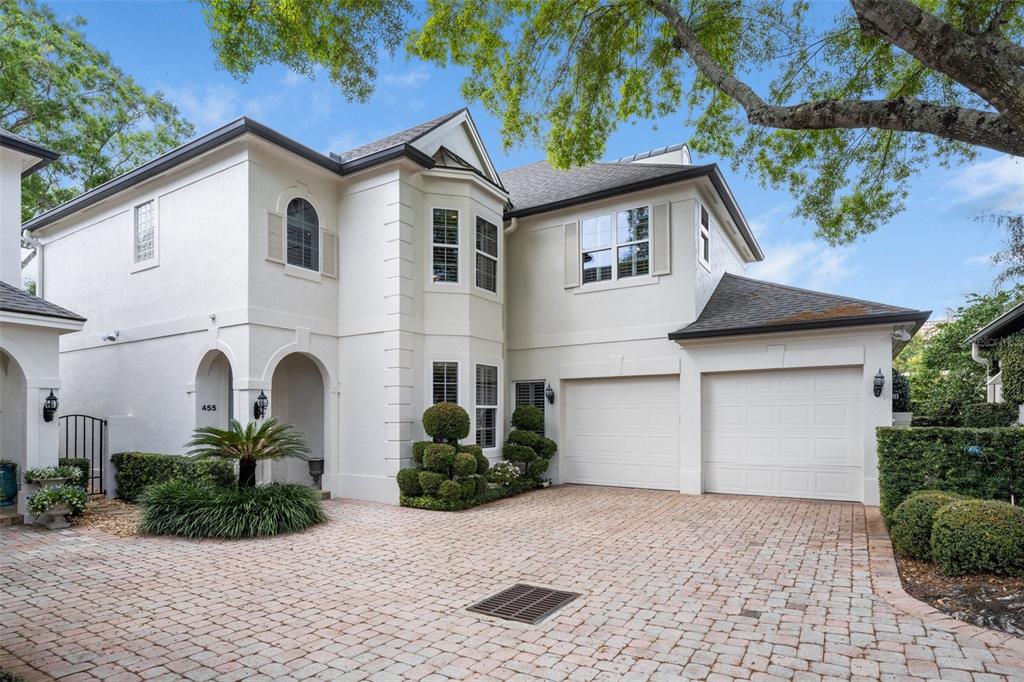 a front view of a house with a yard and a garage