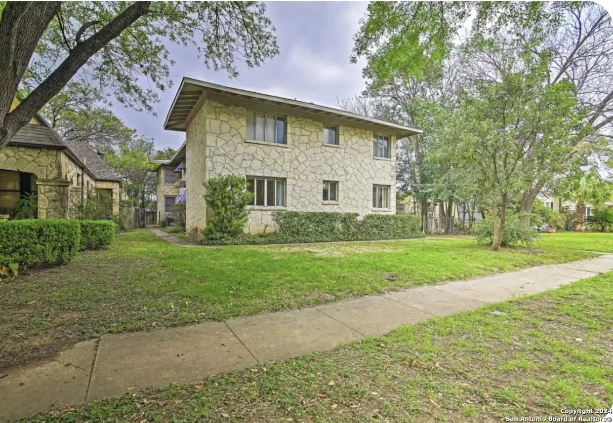 a front view of house with yard and green space