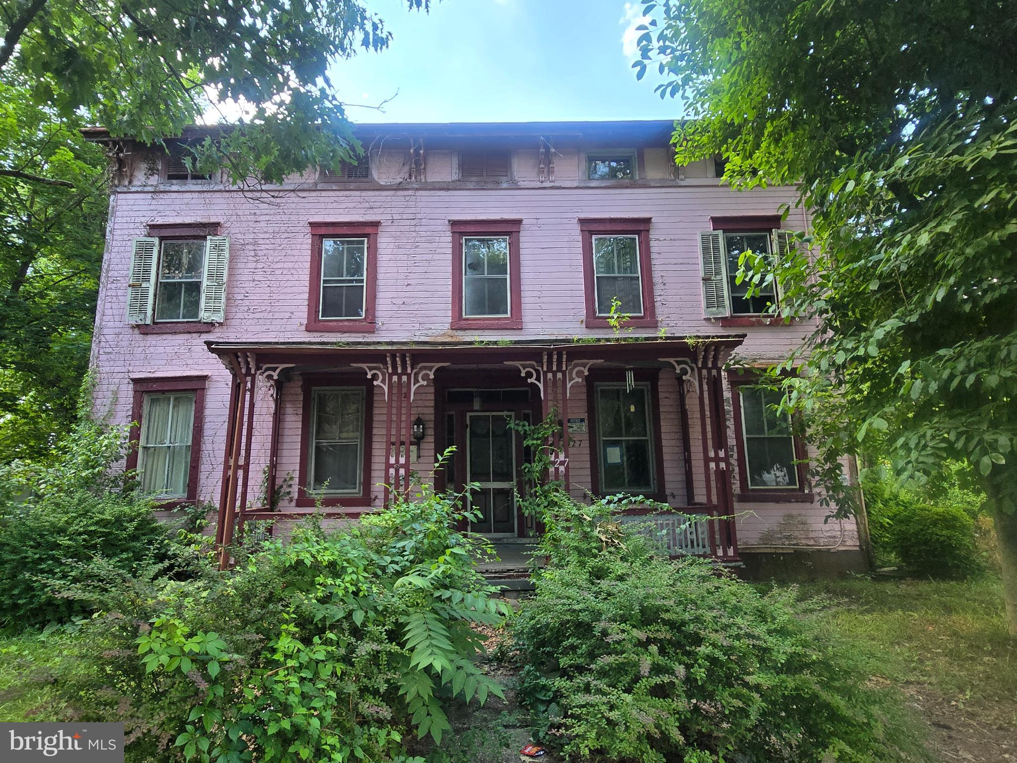 front view of a house with a tree