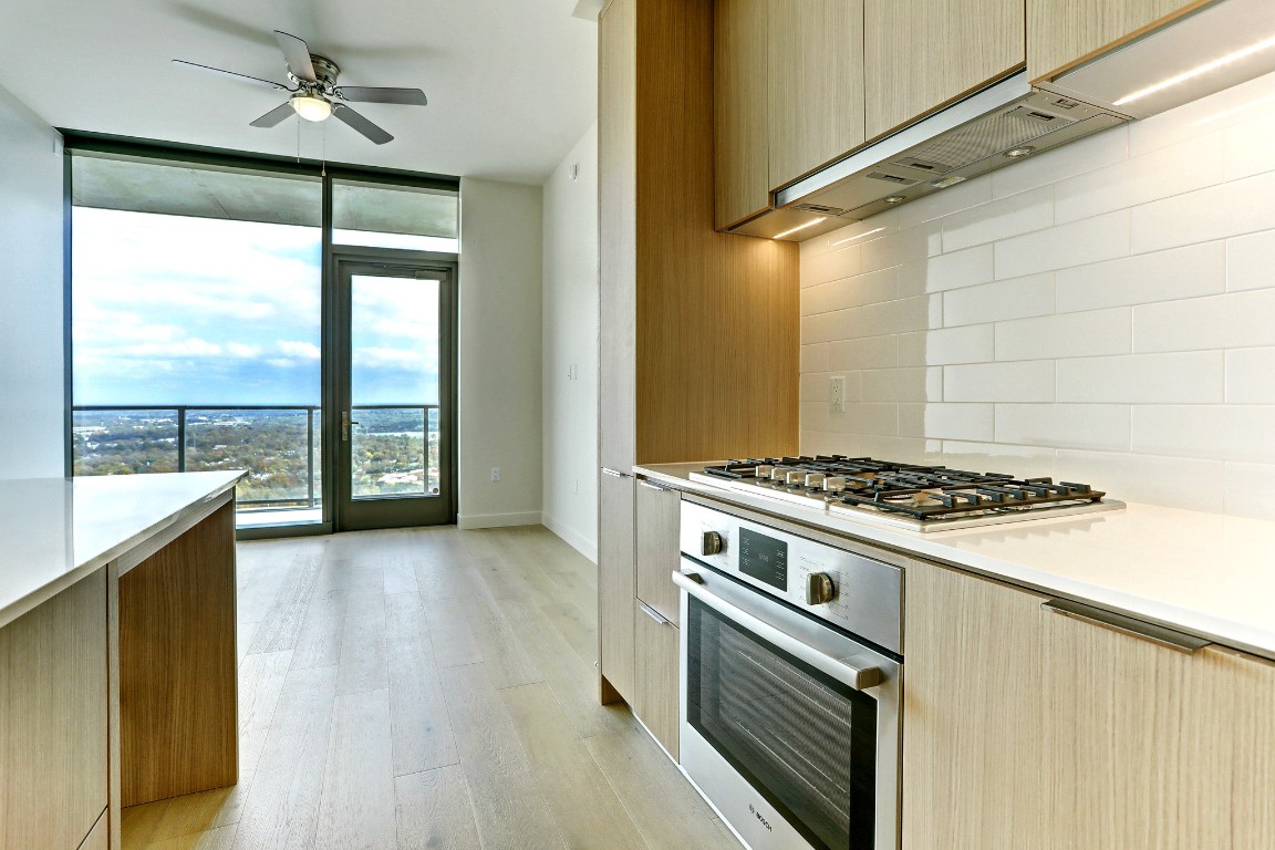 a kitchen with a stove a sink and a refrigerator