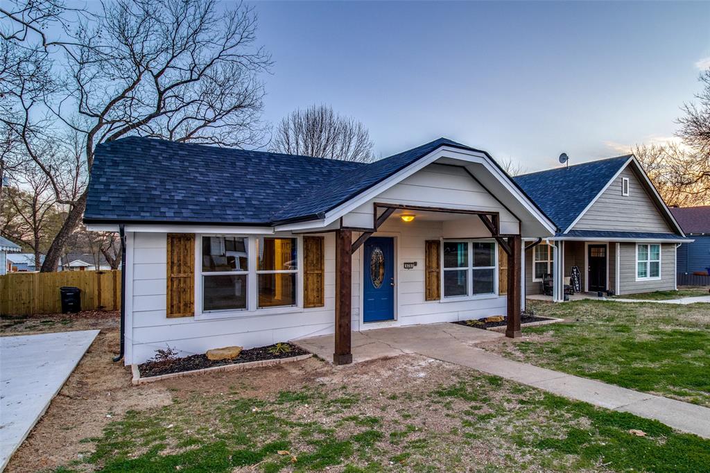 View of front of home with a yard and a porch