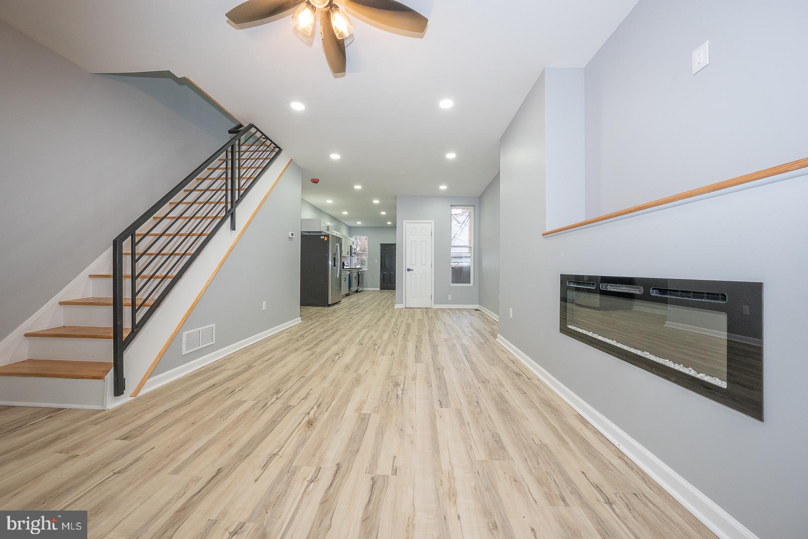 wooden floor in an empty room with a fireplace