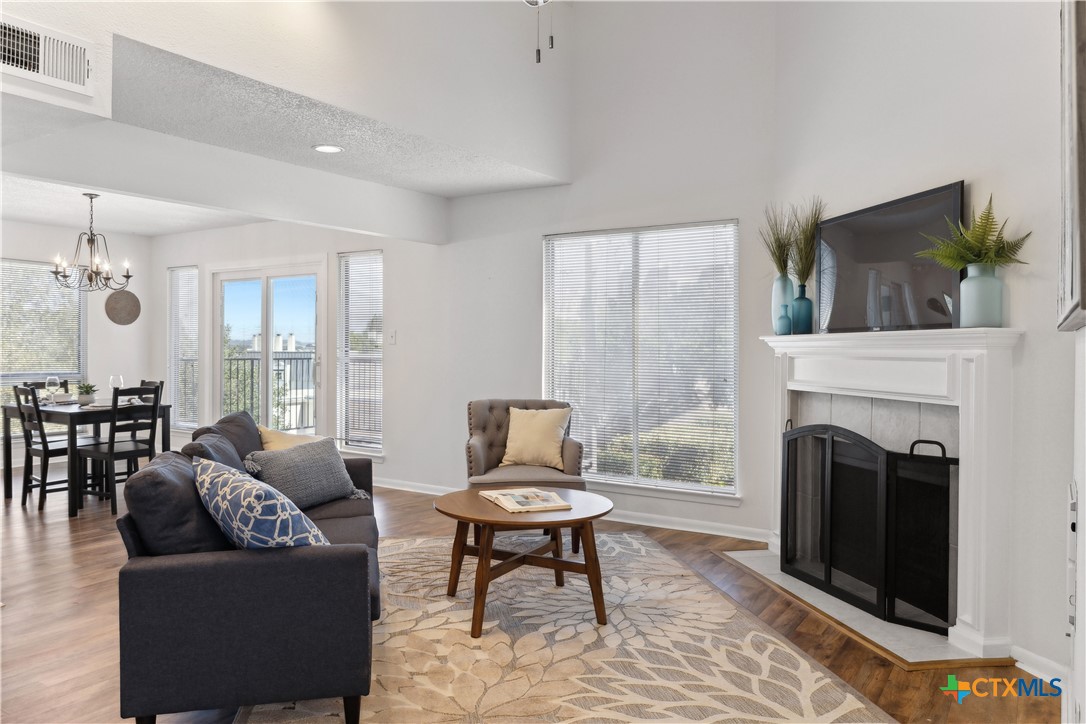 a living room with furniture a fireplace and a flat screen tv