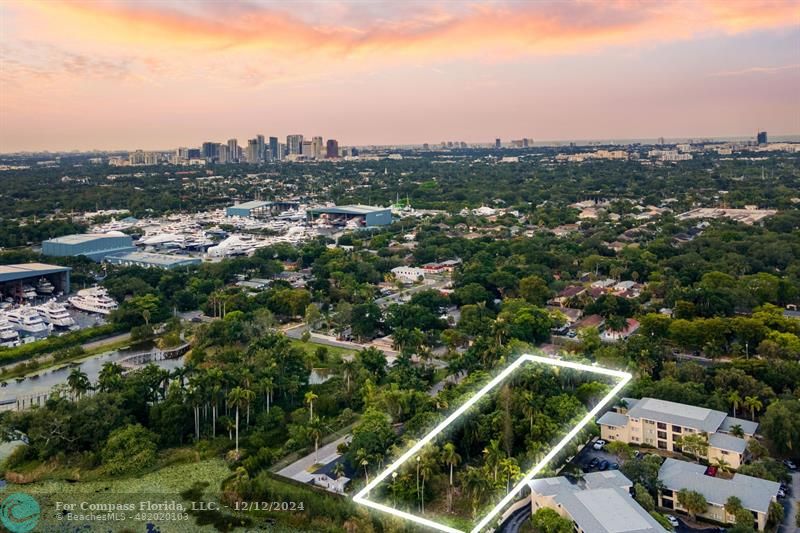 an aerial view of residential houses with city view