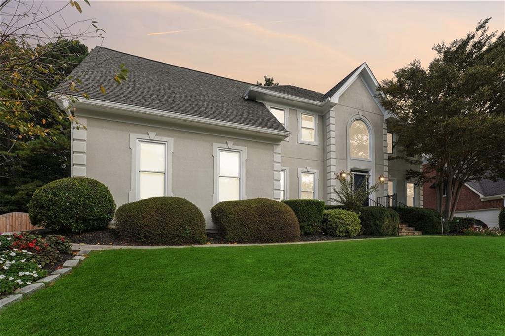 a front view of a house with a garden