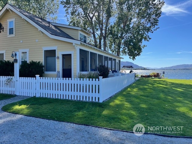 a view of a house with a yard and deck