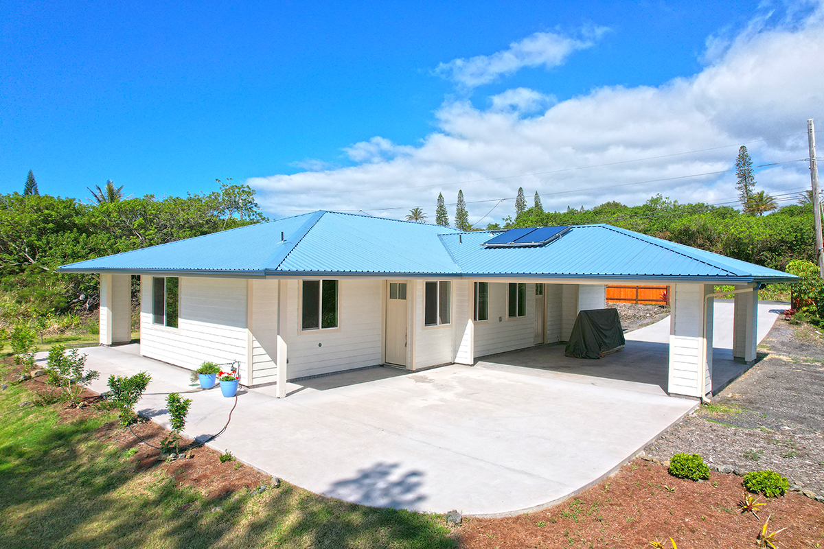 Offered at $679,000. This 2022 built home is on Hole #16 of the Discovery Harbour Golf Course, Discovery Harbour, Naalehu, HI 96772.and has tremendous finishes and thoughtful features. Phot from the rear of the property.
