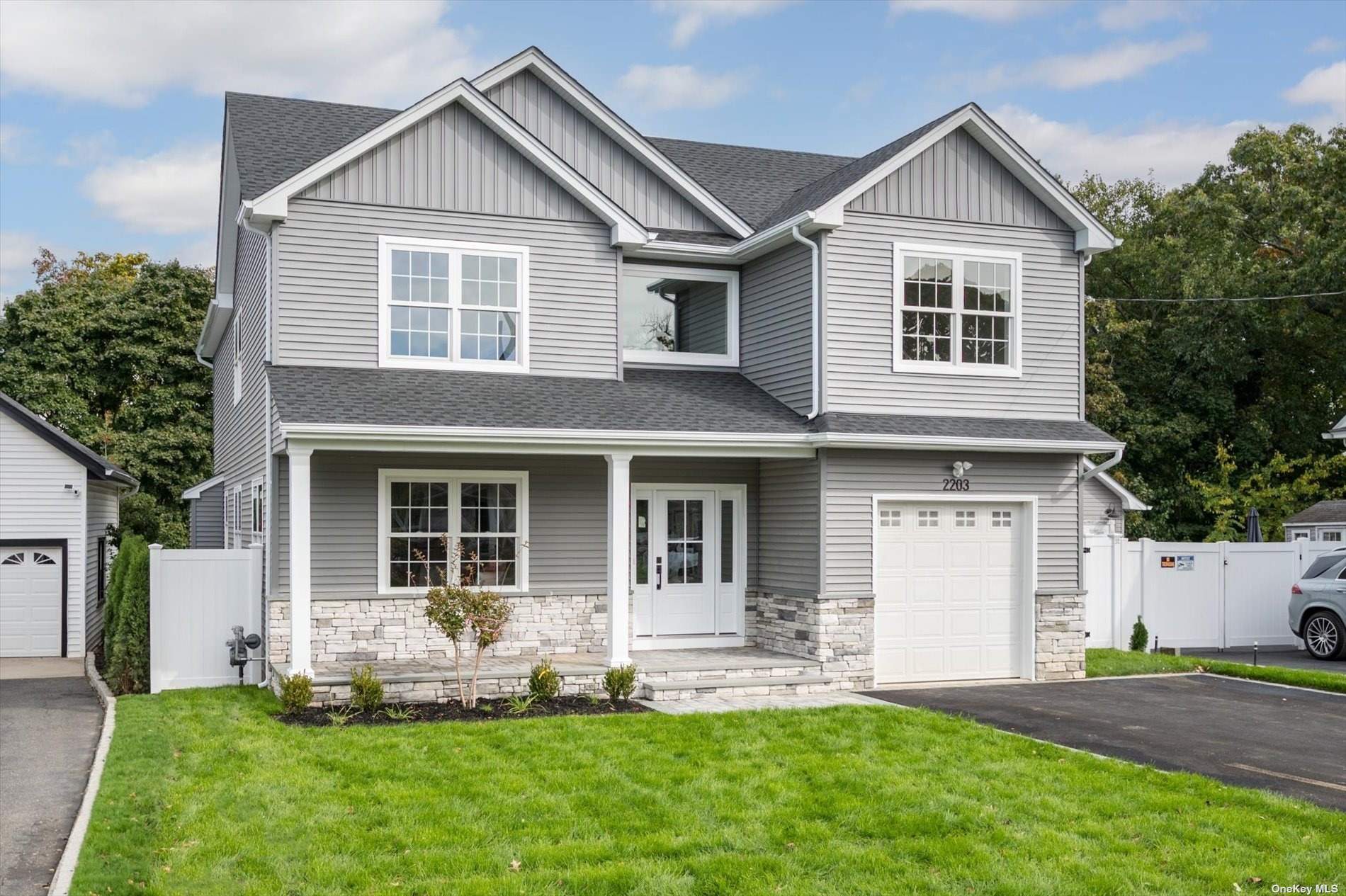 a front view of a house with a yard and porch