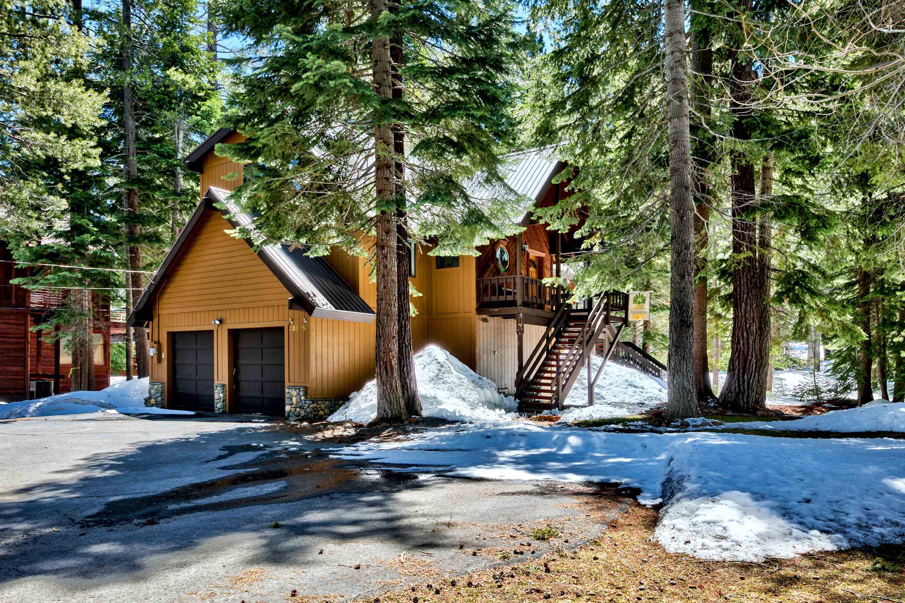 a front view of a house with a tree