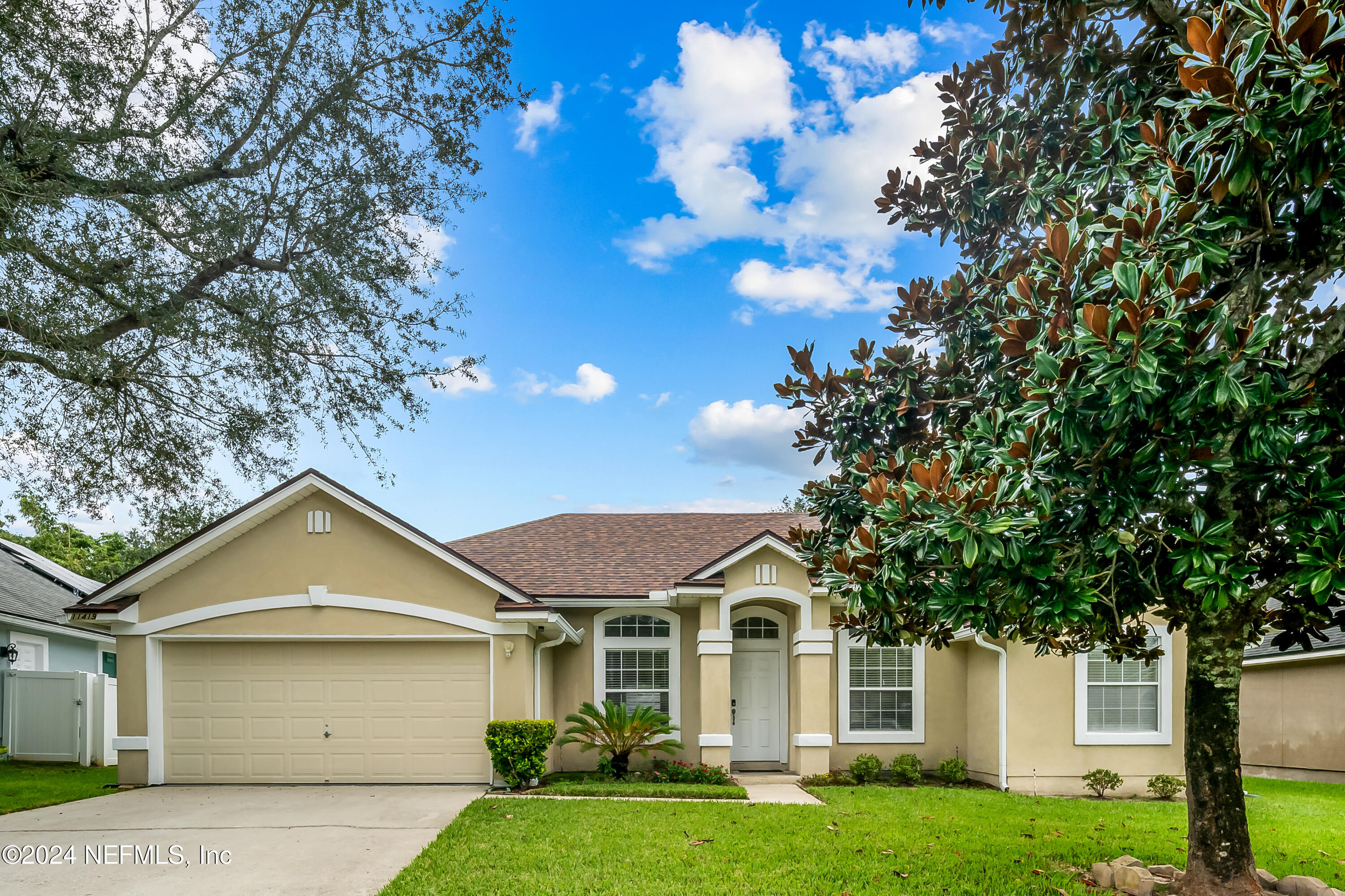 a front view of a house with a yard and garage