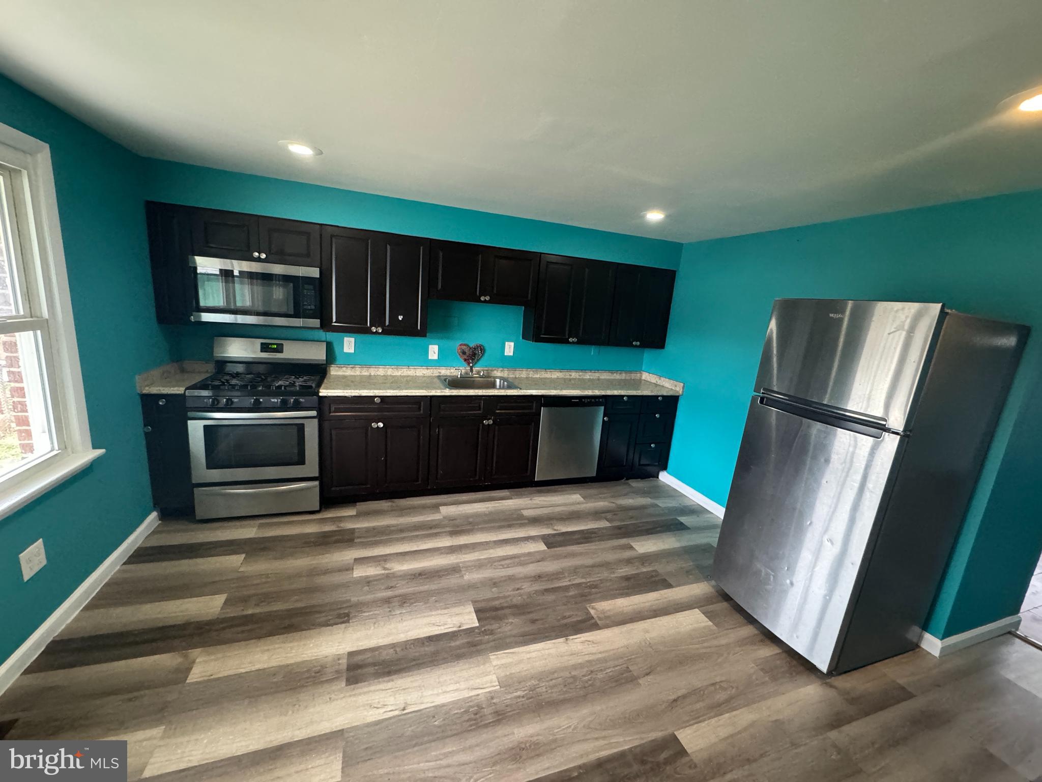 a kitchen with stainless steel appliances a refrigerator and a sink