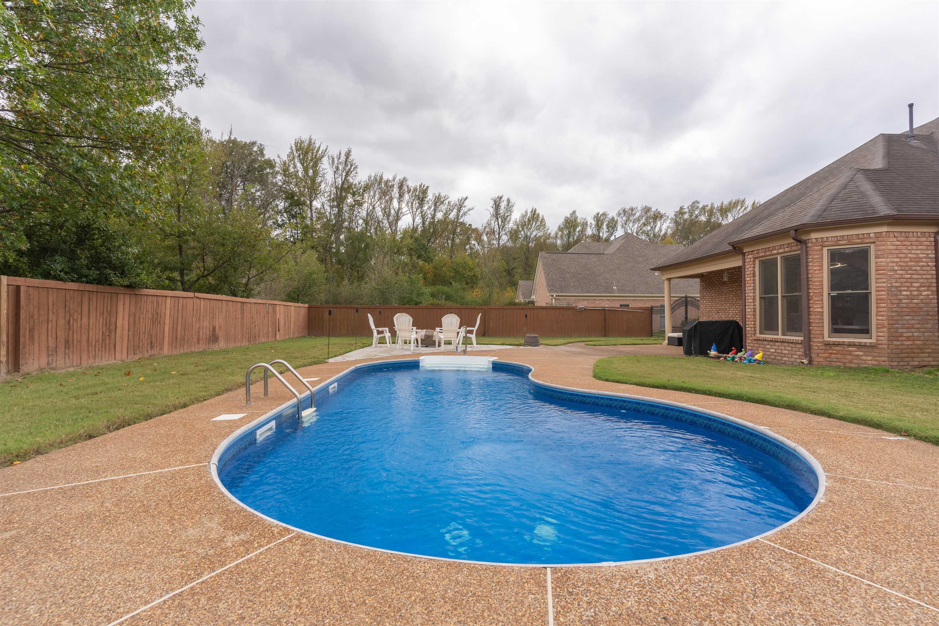 View of swimming pool with a patio area and a lawn