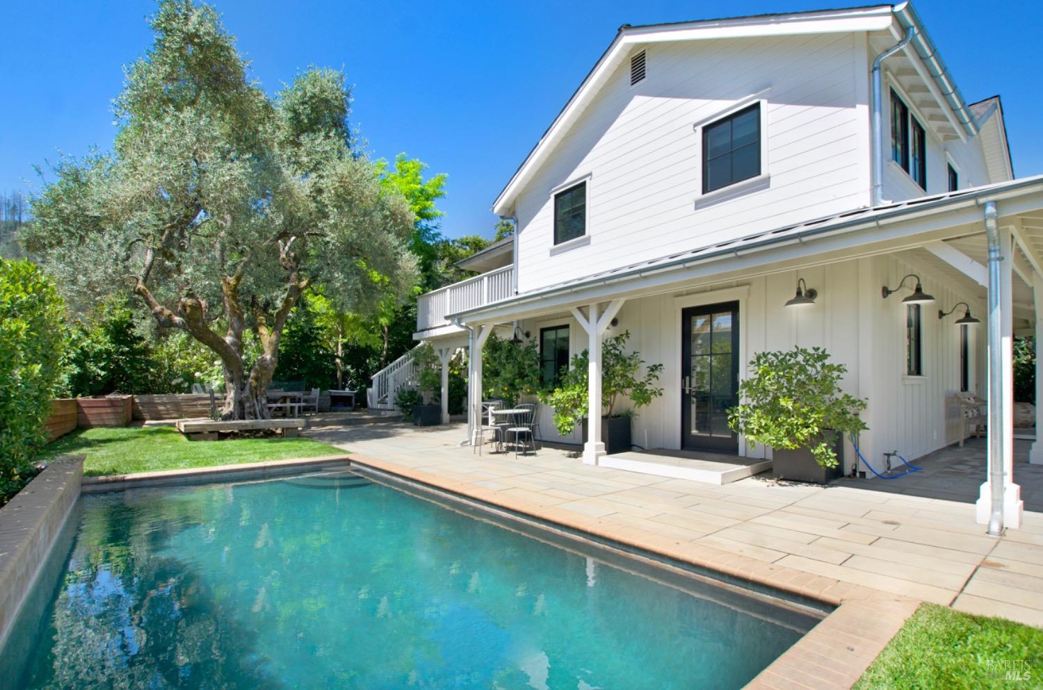 a view of a patio with swimming pool table and chairs