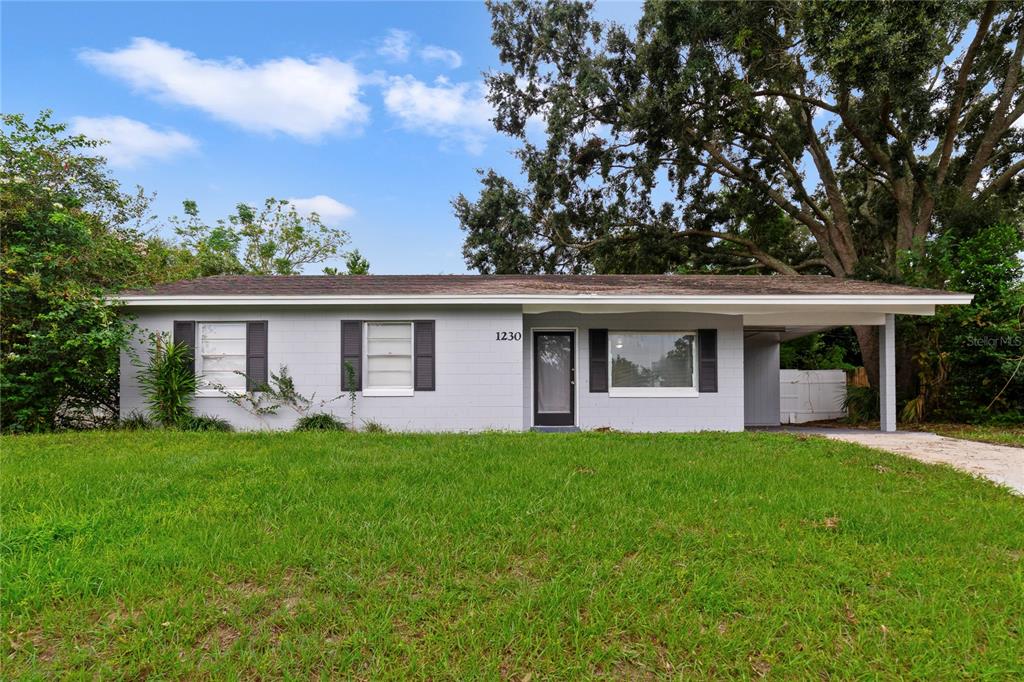 a front view of house with yard and green space