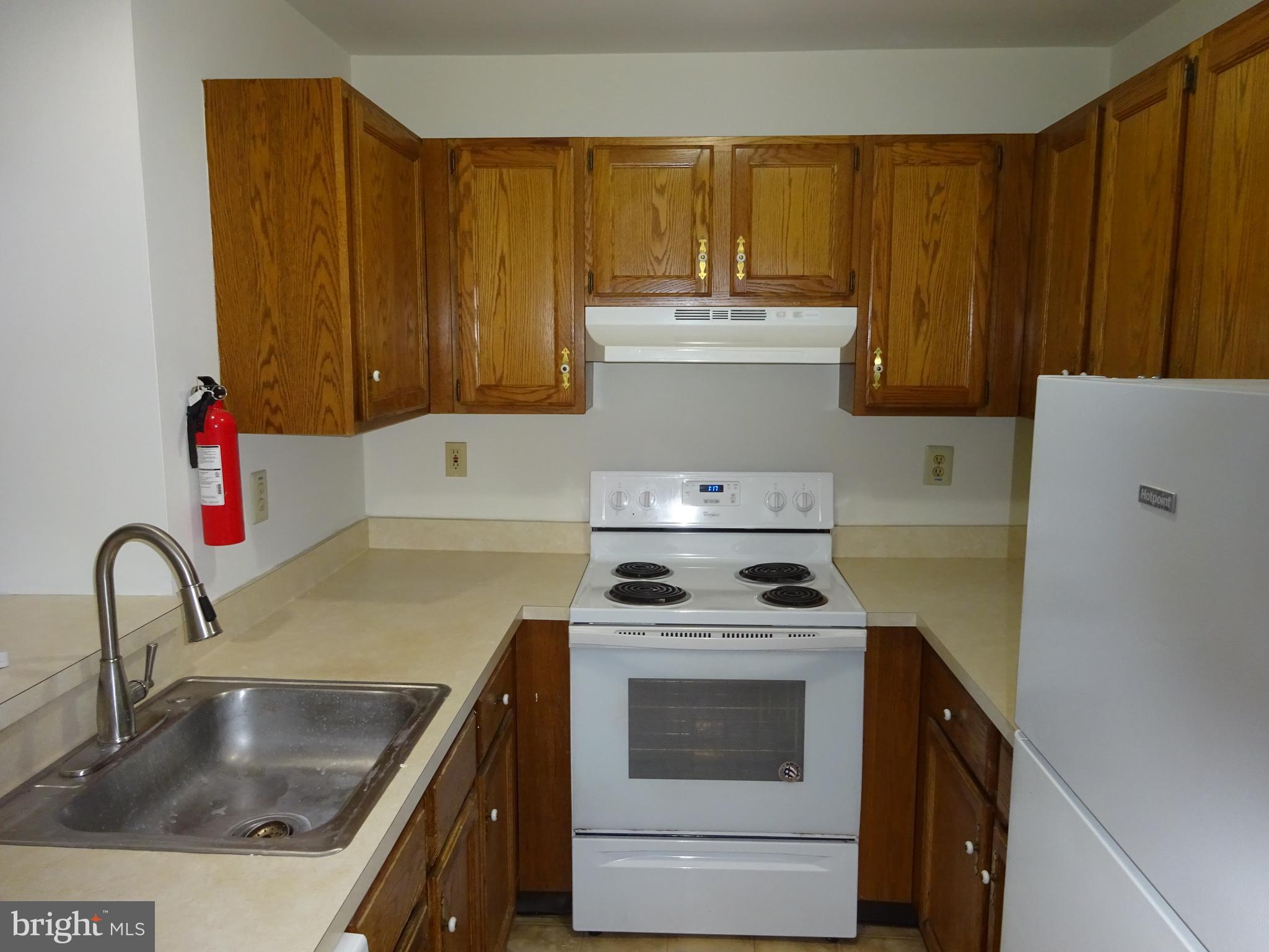 Galley kitchen with dishwasher, electric stove and