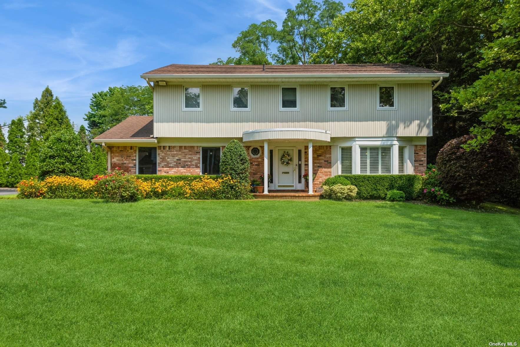 a front view of a house with garden