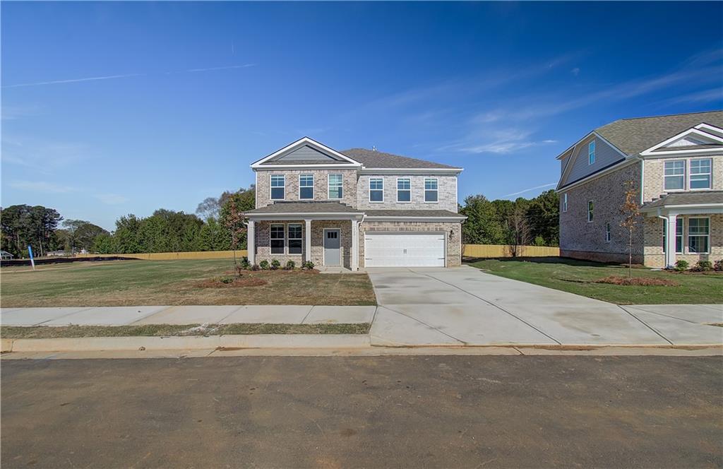 a front view of a house with a yard