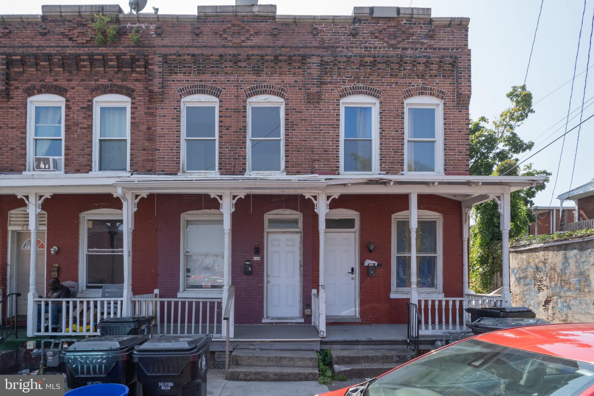 front view of a brick house with a small yard