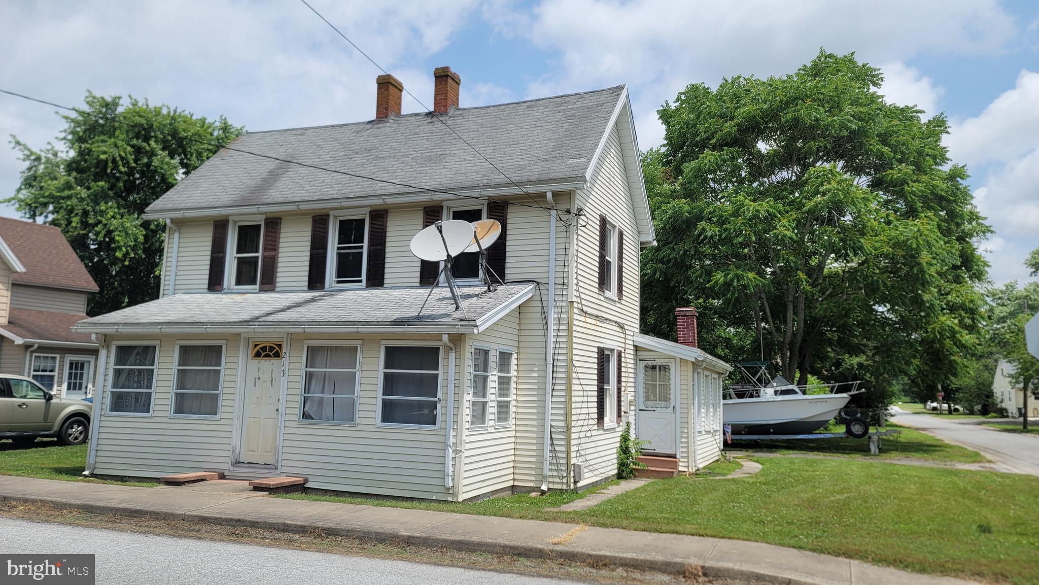 a front view of a house with a garden