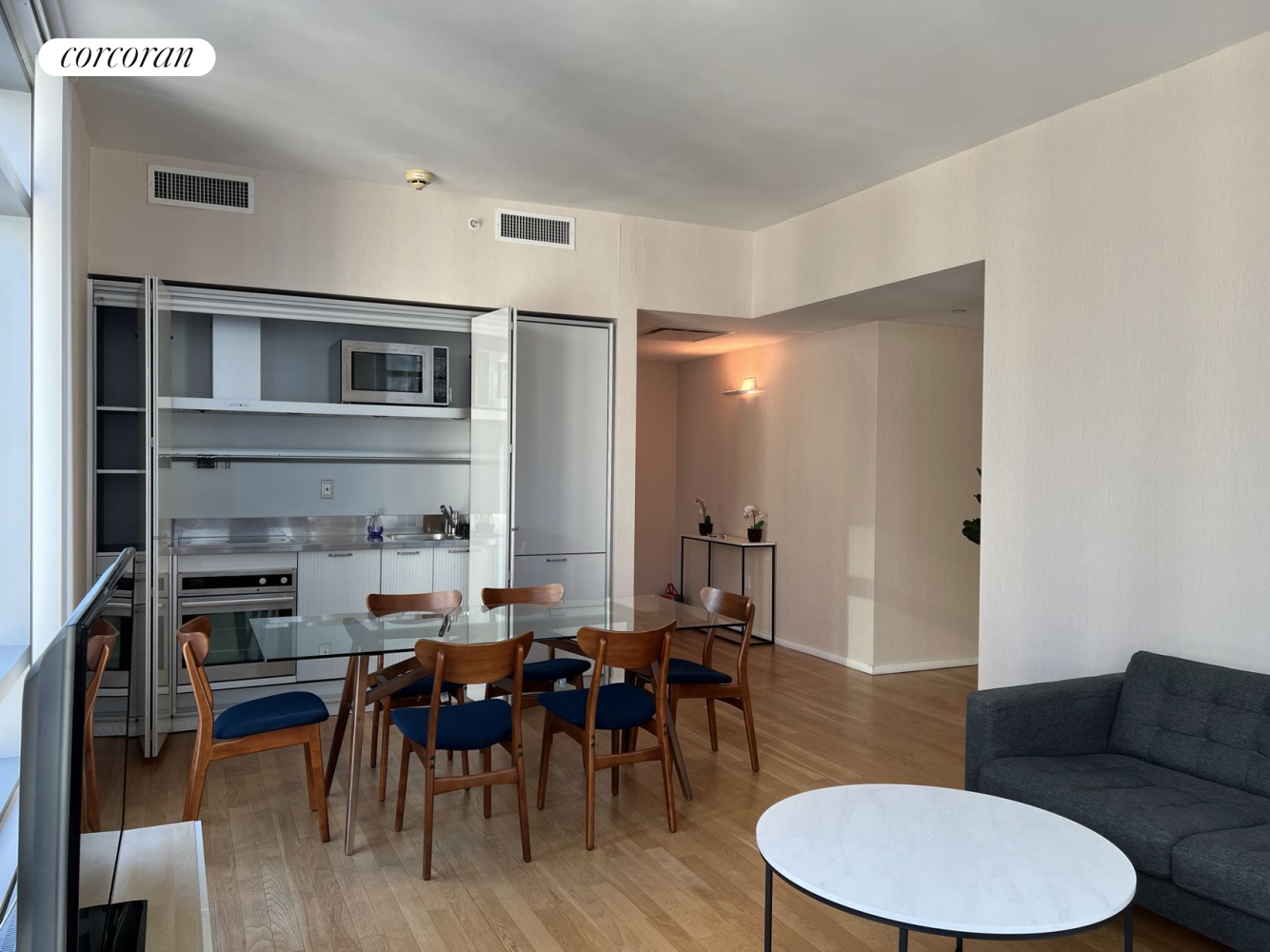 a living room with furniture a dining table and a fireplace