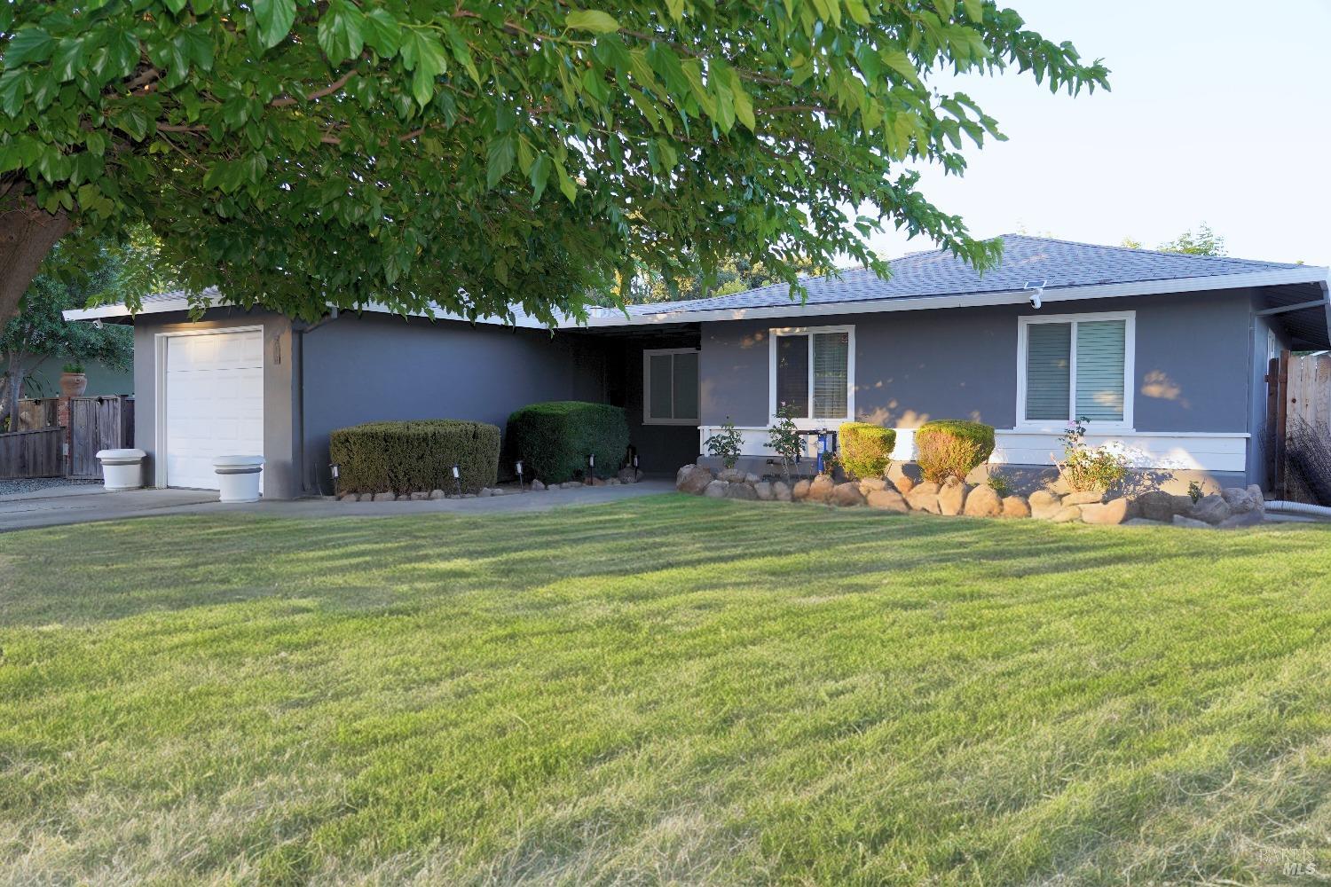 a front view of house with yard and outdoor seating