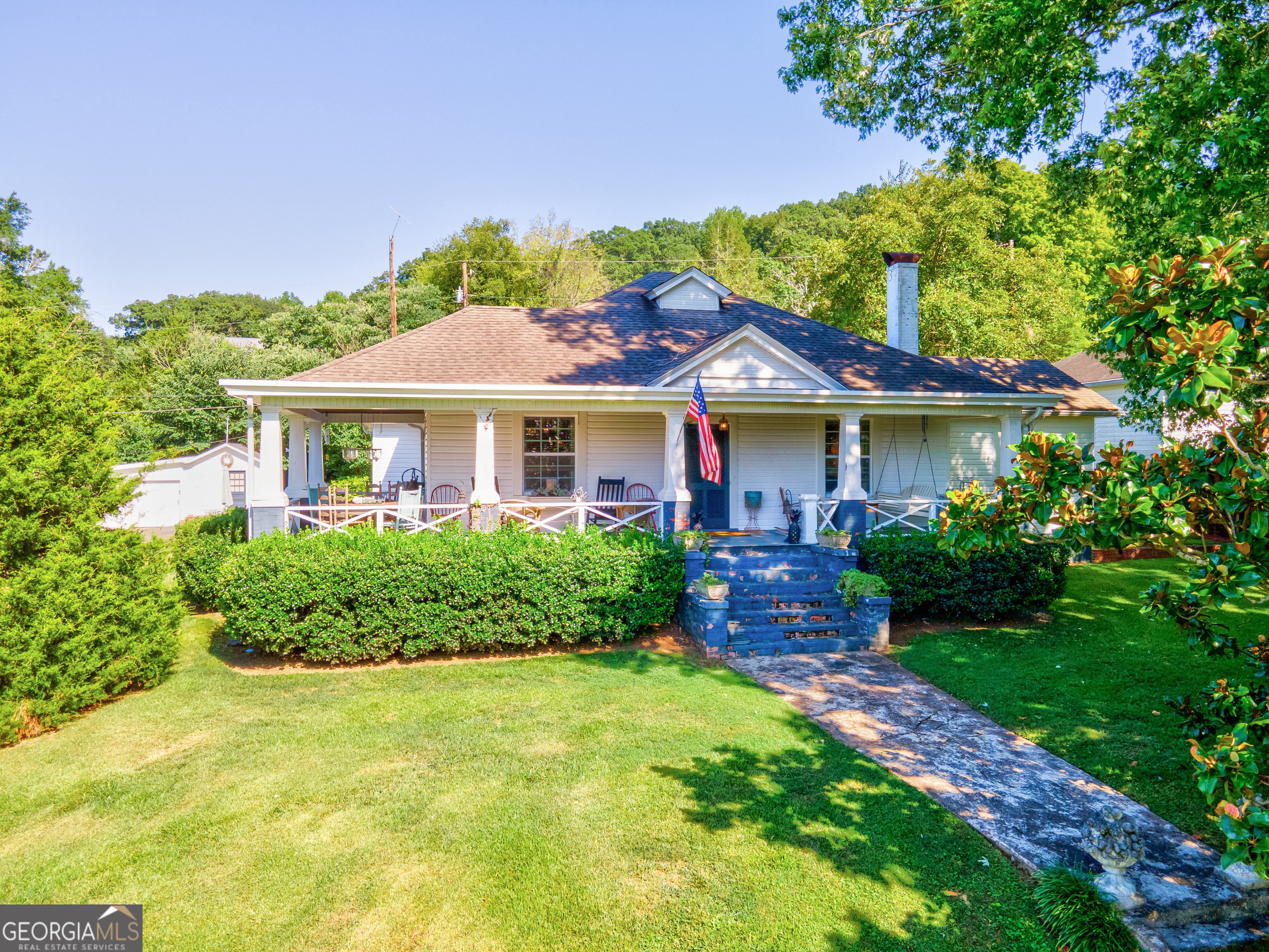 a front view of a house with a garden