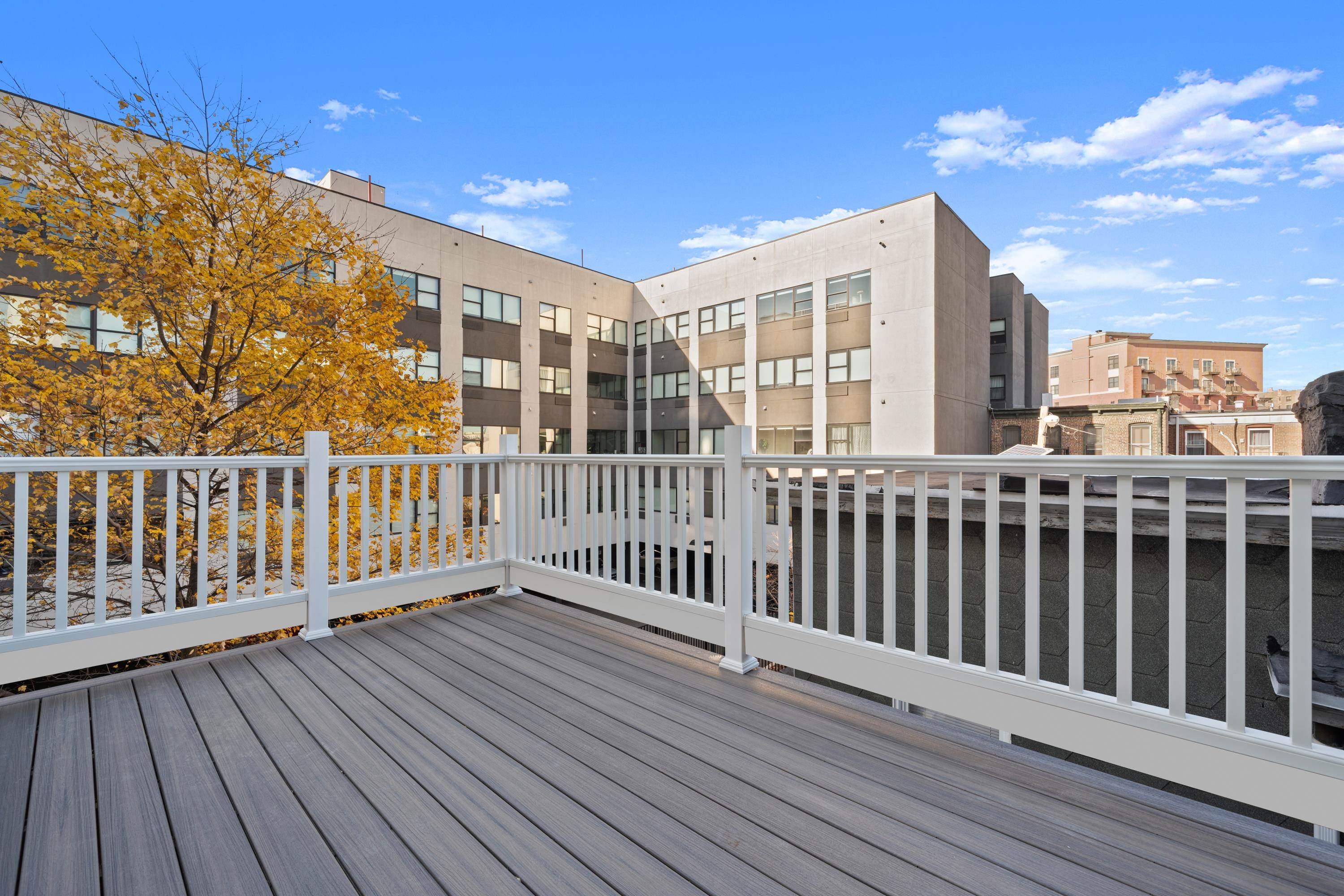 a view of a balcony with wooden floor