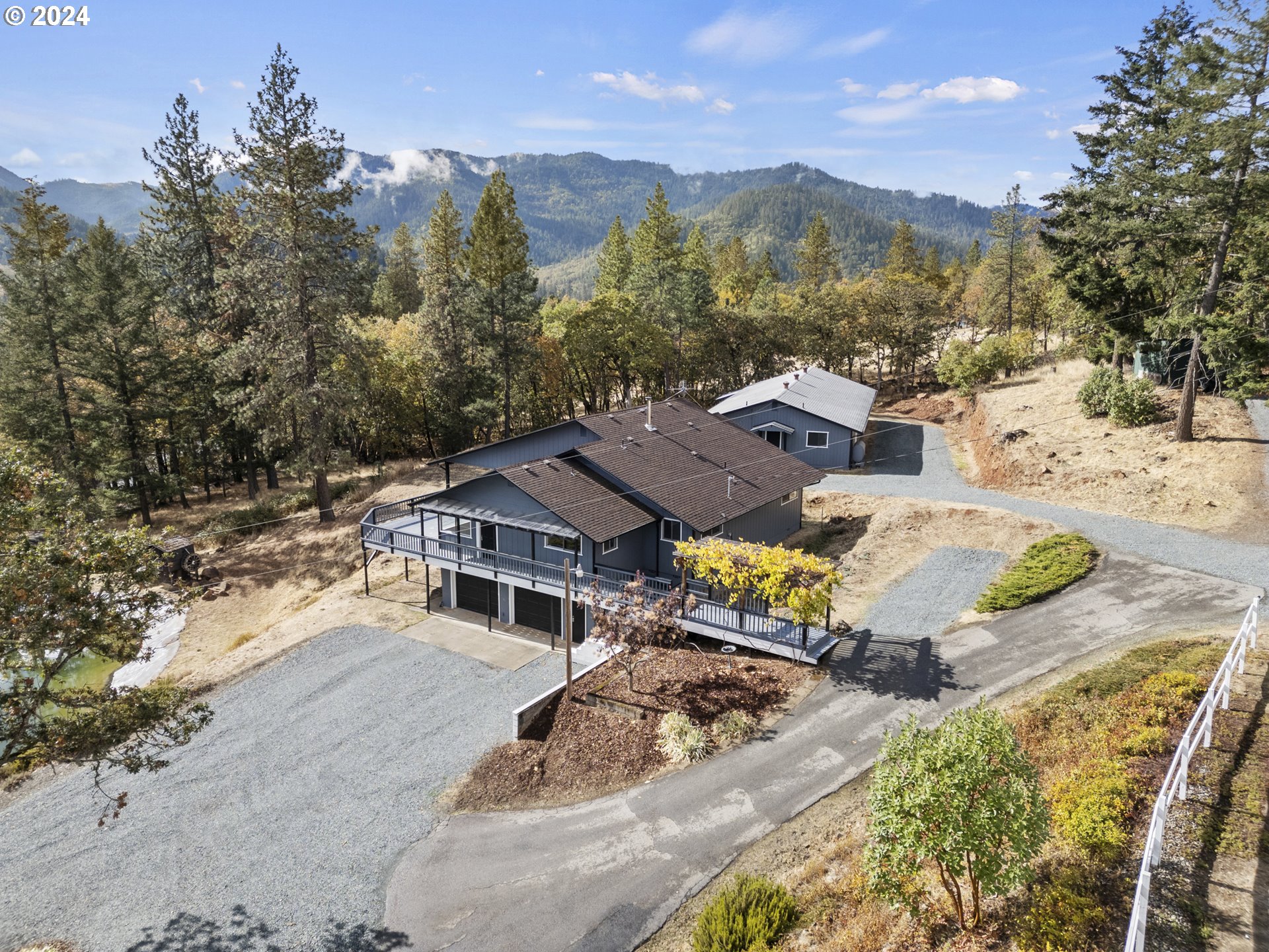 an aerial view of a house with yard swimming pool and mountain view