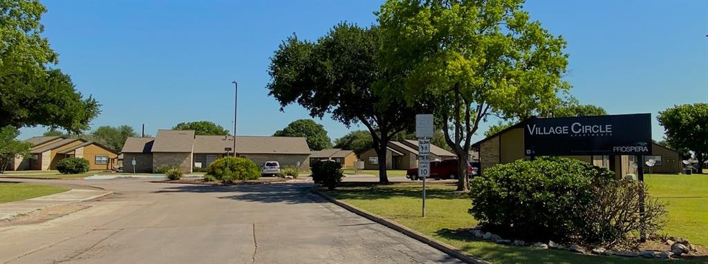 a front view of a house with a yard and tree s