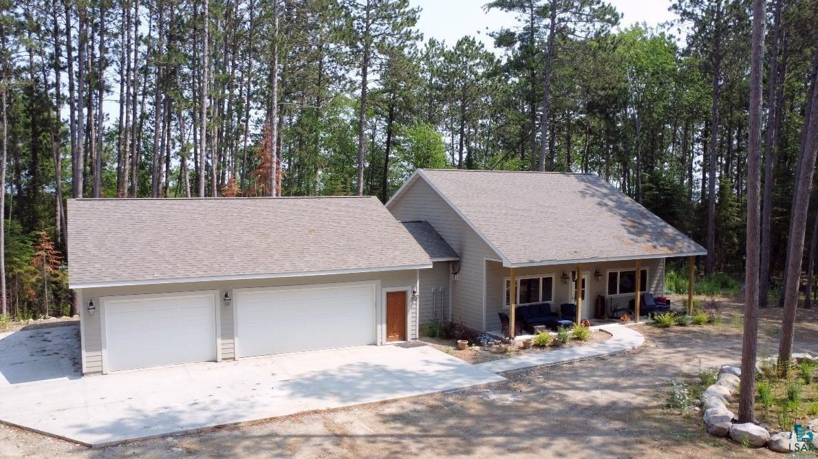 View of front of home featuring a porch and a garage