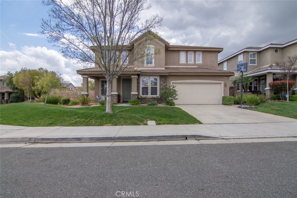 a front view of a house with a yard and garage