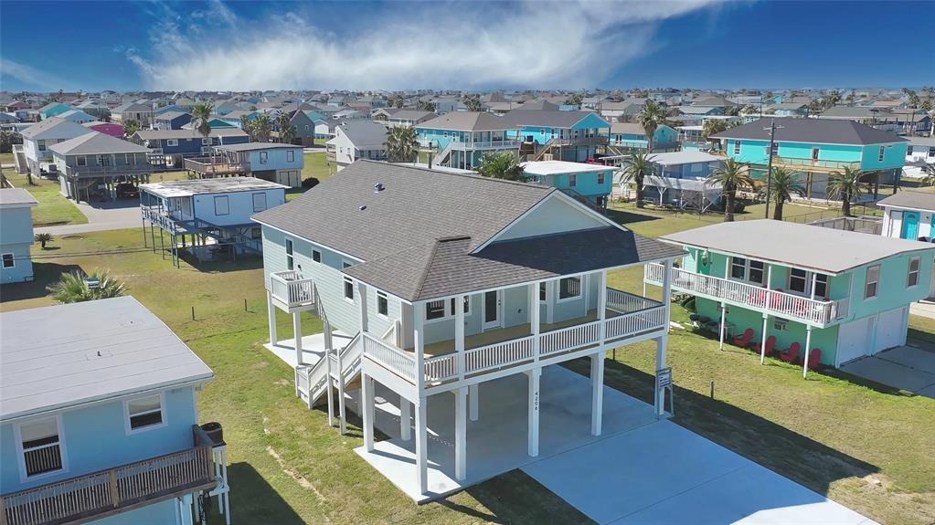 an aerial view of a house with a yard