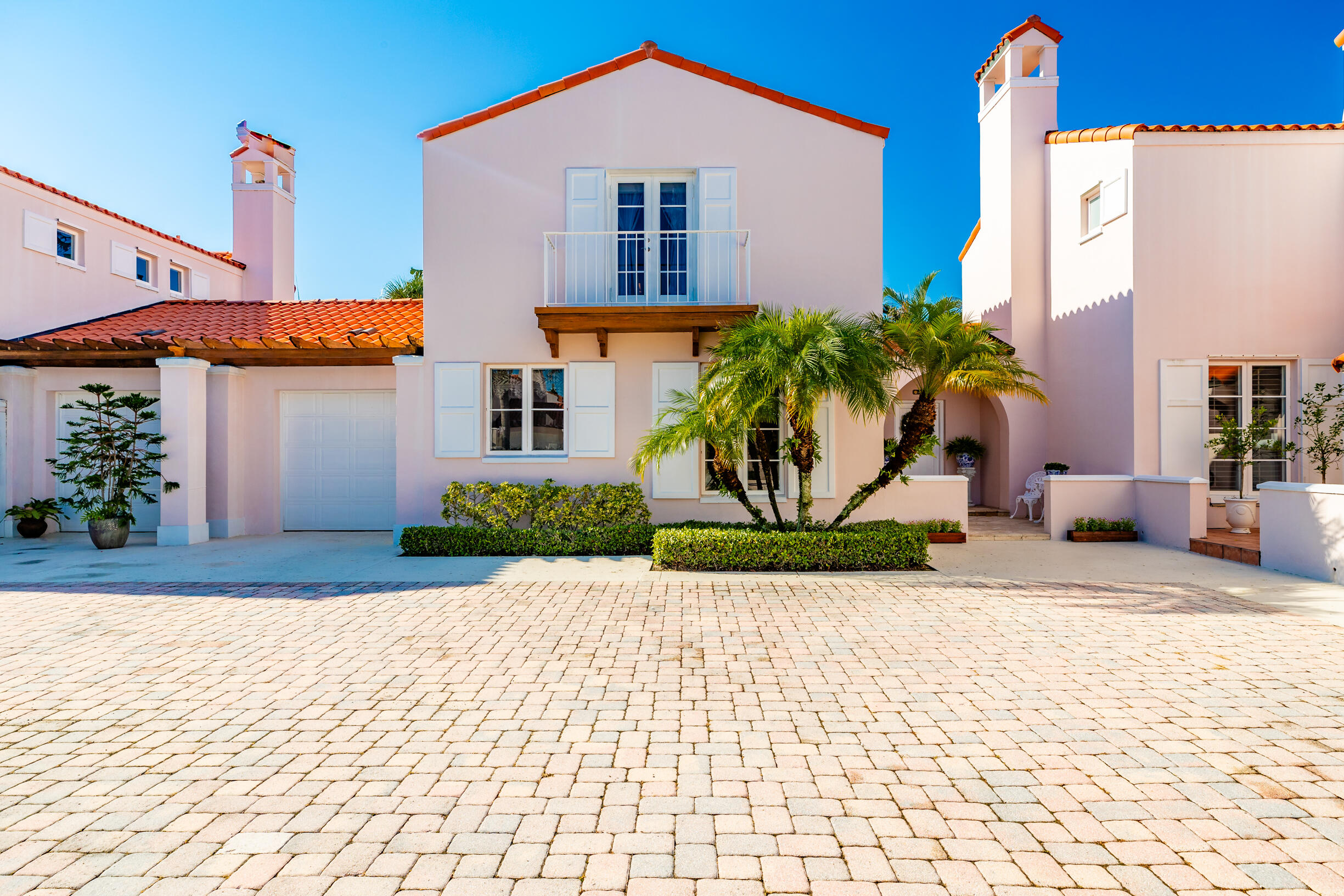 a front view of a house with a yard and a garage