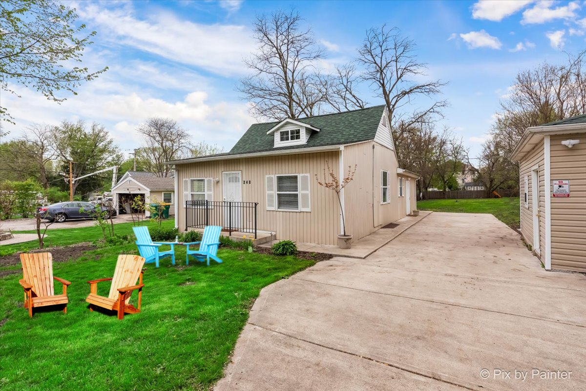 a view of a house with a yard porch and sitting area