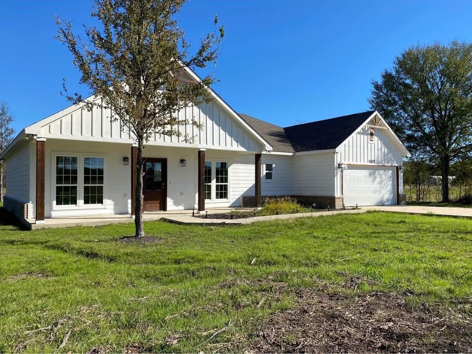 a front view of a house with a yard porch and outdoor seating