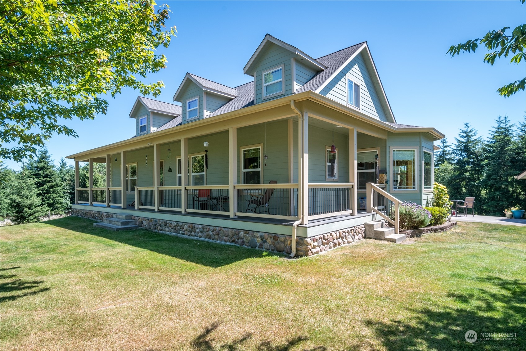 a view of a house with backyard porch and sitting area