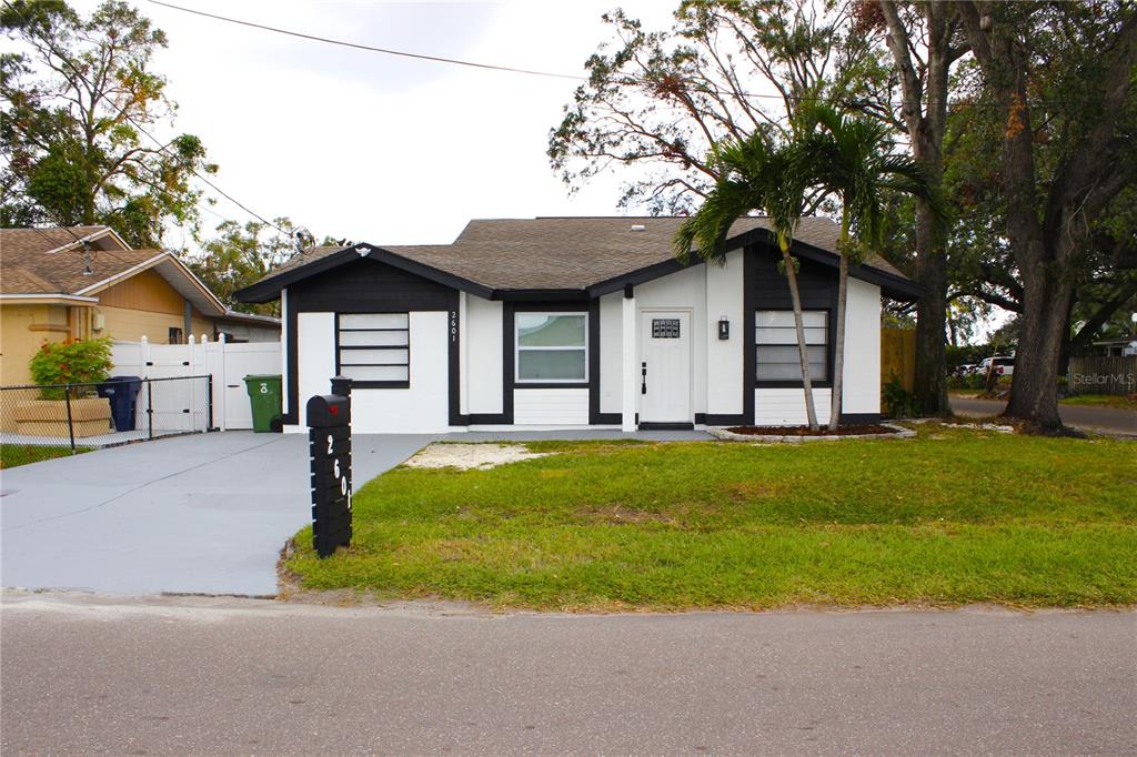 a front view of house with yard and green space