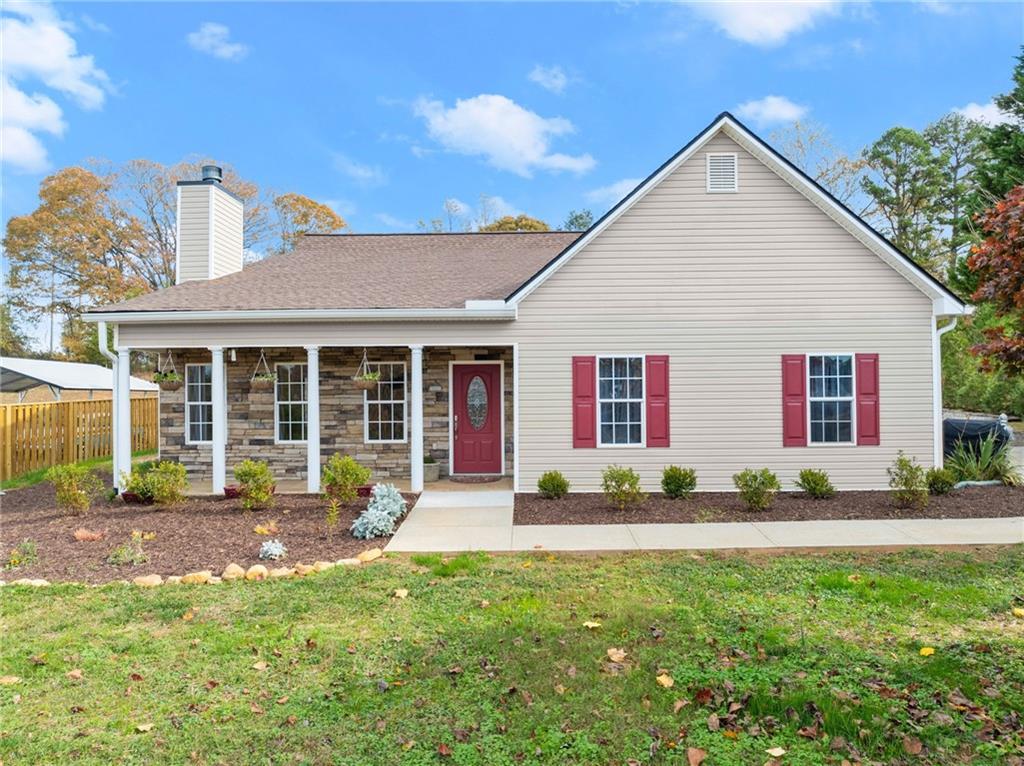 a front view of a house with a yard and outdoor seating